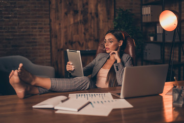 Close up side profile photo beautiful she her business lady chief hard week look e-reader e-book report information learn study compare analyze sit office chair wear specs formal wear checkered suit