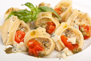 pasta shell stuffed with various cheese, pesto sauce and cherry tomatoes