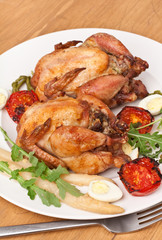 whole grilled chickens garnished with vegetables