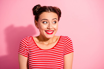 Close up photo beautiful she her lady pretty two buns pomade lips look up empty space toothy show white teeth sly know secret giggling wear casual striped red white t-shirt isolated pink background