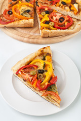 slices of vegetable pizza on white background