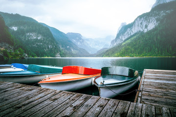 boats in the beautiful gosau lake, gosausee and mountains in the background. austria