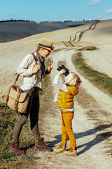 Fototapeta premium mother and child hikers looking on each other through binoculars