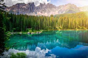 lago di carezza or karersee is a beautiful lake in the dolomites mountains, mont latemar in the background, south tyrol, italy