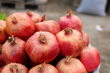  Red pomegranates for sale at a fruit market