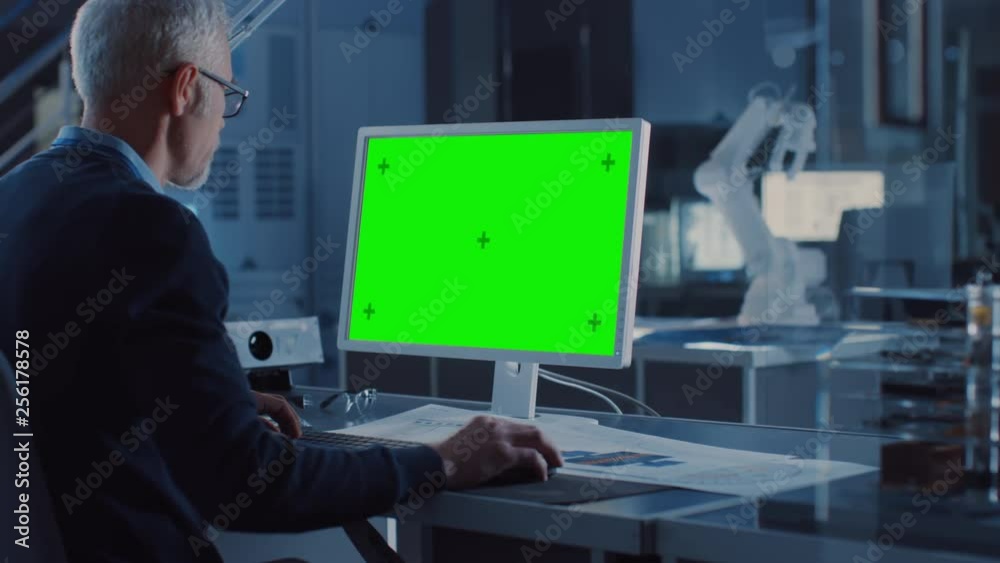 Poster professional heavy industry engineer works on green mock-up screen computer. engineering bureau and 