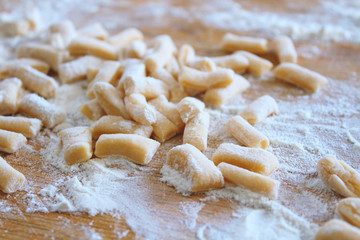 Chopped dough slices. Billet for chuck chuck. Dough and flour on a wooden board. Close-up. Background. Texture.