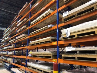 Orange racks with pallets on the right side