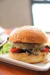 Beef Hamburger  with fries and salad on wooden background