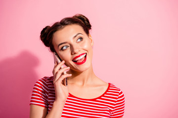 Close-up portrait of her she nice-looking cute attractive fascinating glamorous cheerful cheery girl wearing striped t-shirt talking on phone isolated over pink pastel background