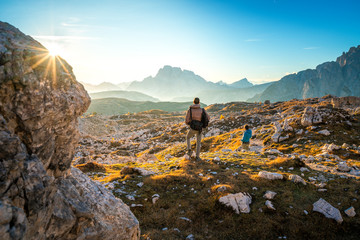 two young man enjoying the view of the mountains landscape in the dolomites national park, south tyrol