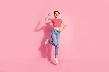 Fototapeta na wymiar Full length body size photo beautiful she her lady jump high recommend buy buyer new product show look empty space wear casual jeans denim striped red white t-shirt sit floor isolated pink background
