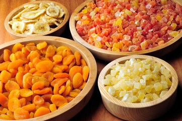 Dried and candied fruits in wooden bowls