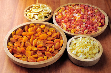 Dried and candied fruits in wooden bowls