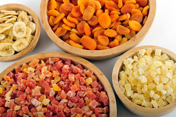 Dried and candied fruits in wooden bowls