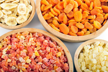 Dried and candied fruits in wooden bowls