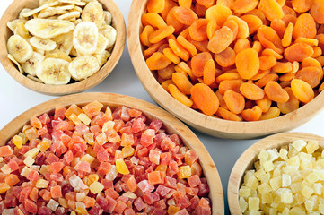 Dried and candied fruits in wooden bowls