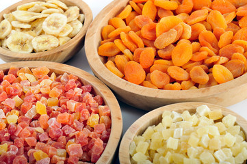 Dried and candied fruits in wooden bowls