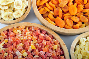 Dried and candied fruits in wooden bowls