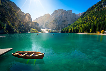 amazing view of braies lake with wooden boats on the water, surrounded by dolomites mountains....