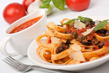 Linguine pasta with fresh tomato puttanesca sauce, cheese and basil