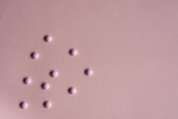 Flat lay medicine.Assorted pills on pink background.Copy space for text. pharmaceutical drugs.Treatment of disease.Сolds.Minimalism for pharmacy. Vitamins during the illness