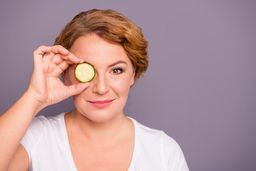 Close up photo beautiful amazing mature she her lady spa procedures hold cucumber slice hide eye nature treatment ideal condition under eyes bags wear white t-shirt isolated grey background