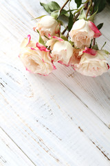 White roses on a wooden background