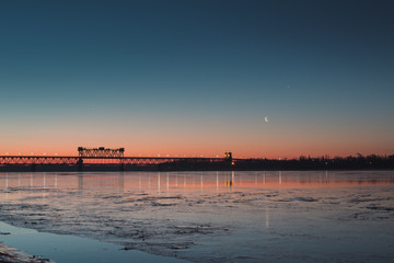 Early morning on the river coast. New moon.