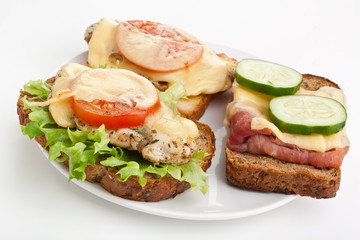 three hot chicken and ham sandwiches