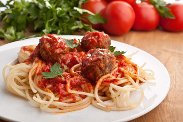 spaghetti with meatballs in tomato sauce on a plate