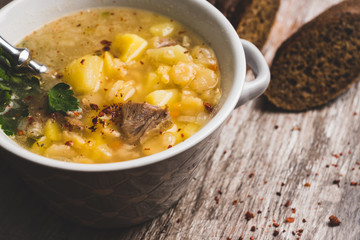 Fat meat soup with lamb based broth, chickpea and potatoes. Selective focus.