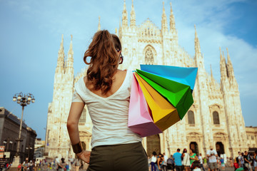 solo tourist woman with colorful shopping bags in Milan, Italy