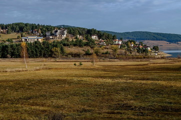 Obraz premium Batak dam with rest homes at the Rodopi mountain Bulgaria
