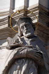 Statue of Saint John of Nepomuk, detail of Holy Trinity plague column in front of Matthias Church...