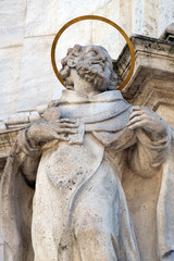 Fototapeta na wymiar Statue of Saint Augustine of Hippo, detail of Holy Trinity plague column in front of Matthias Church in Budapest, Hungary