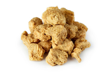 Raw soya chunks, soy meat for vegans isolated on white background