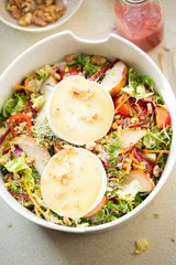 Salad with lettuce,  brie, fried pears, camembert, walnuts, red onion, tomatoes and raspberry vinaigrette dressing