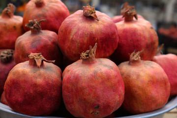 Red pomegranates for sale at a fruit market
