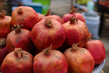 Red pomegranates for sale at a fruit market