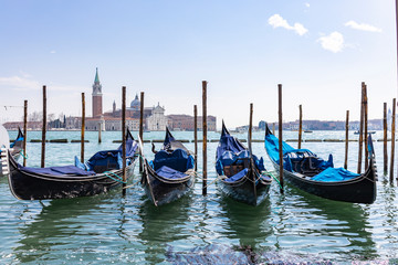 Fototapeta na wymiar Empty gondolas floating on a lagoon of Venice, Italy