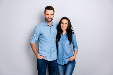 Close up portrait beautiful amazing cheer she her he him his couple lady guy friends stand close hands arms pockets wear casual jeans denim shirts outfit clothes isolated light grey background