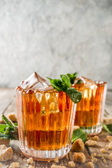 Summer iced mint tea. Traditional Moroccan drink  with mint. Rustic wooden background, copy space