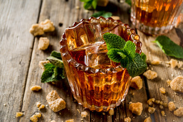 Summer iced mint tea. Traditional Moroccan drink  with mint. Rustic wooden background, copy space