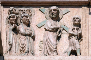 Path towards the Calvary, relief on Facade of Sant`Anastasia Church in Verona, Italy