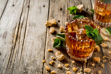 Summer iced mint tea. Traditional Moroccan drink  with mint. Rustic wooden background, copy space