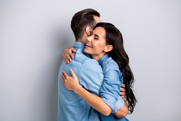Sweetheart dear profile side photo handsome casual fashionable modern guy girl are meeting getting warm hugs closing eyes isolated on grey background in blue clothing 