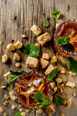 Summer iced mint tea. Traditional Moroccan drink  with mint. Rustic wooden background, copy space