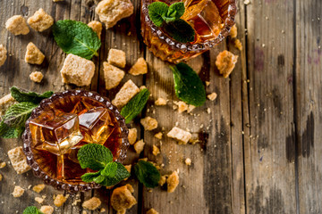 Summer iced mint tea. Traditional Moroccan drink  with mint. Rustic wooden background, copy space