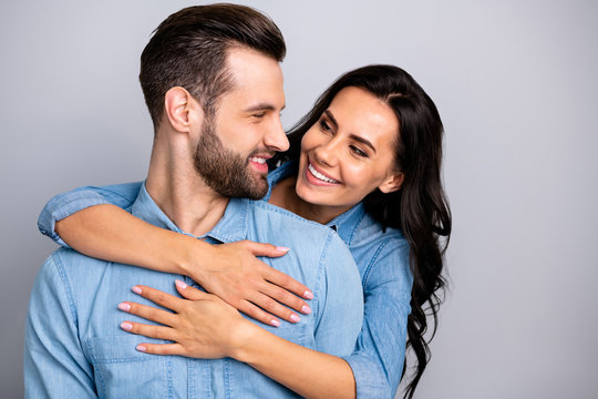 Portrait of charming handsome young sweethearts crazy in love enjoying peaceful gentle beloved isolated wearing blue denim shirts on argent background  